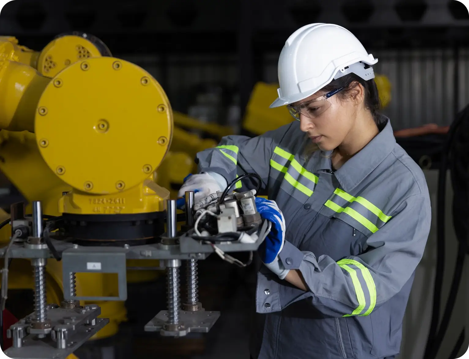 Engineer working on industrial machinery assembly.