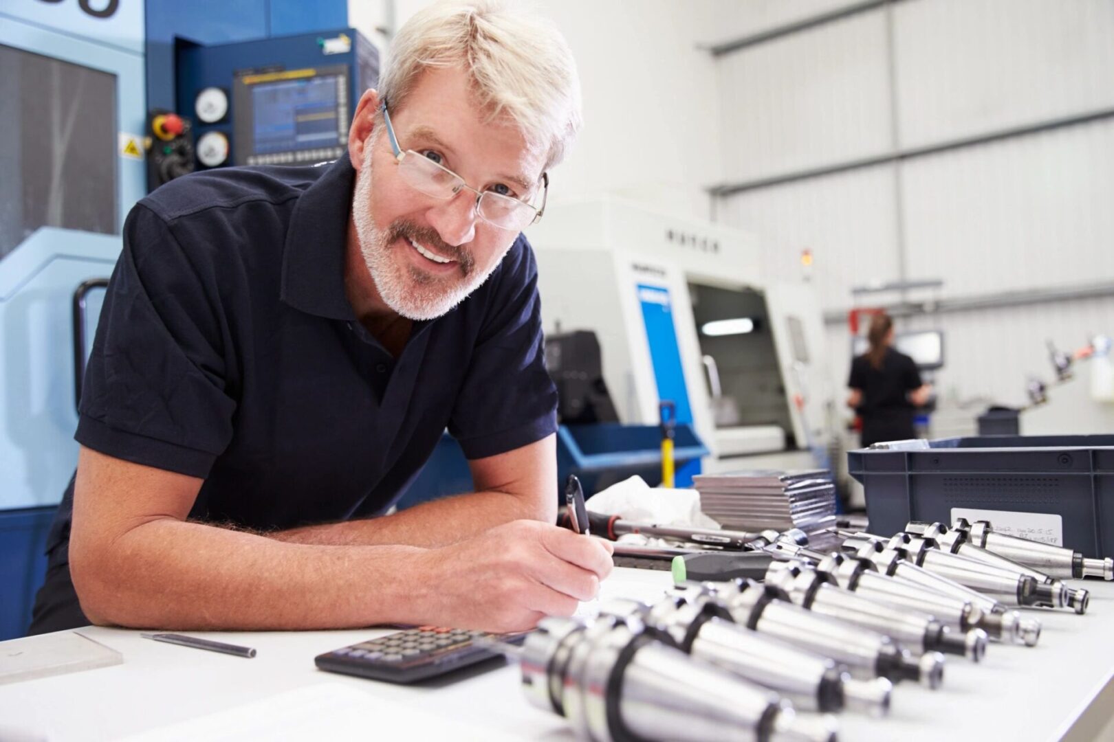 Engineer inspecting mechanical parts in a workshop.